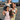 Three young girls in floral dresses holding a doll, promoting empathy through play and storytelling.